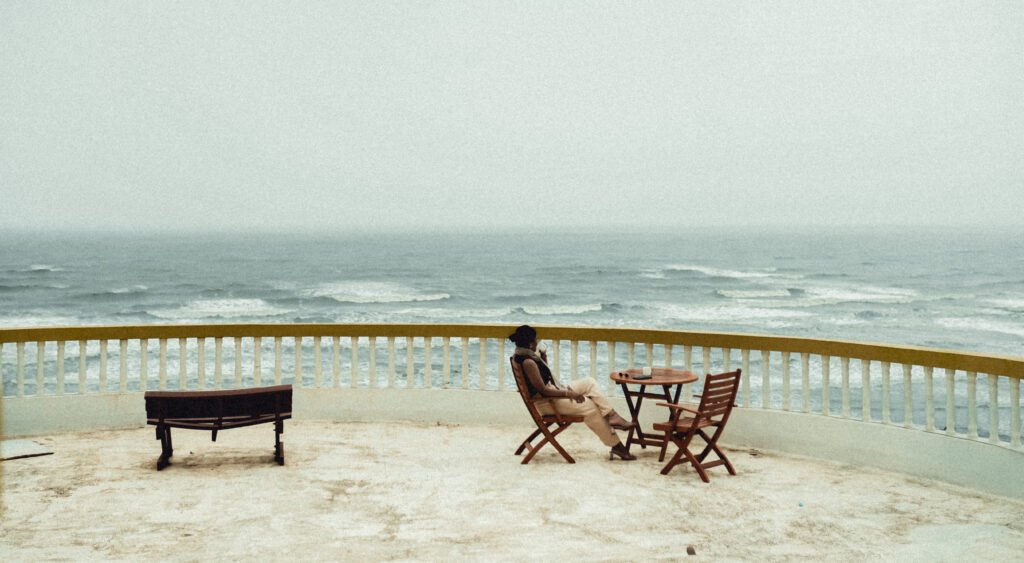 Woman enjoying coffee at sea-facing private villa in Dapoli – Villa Infinity