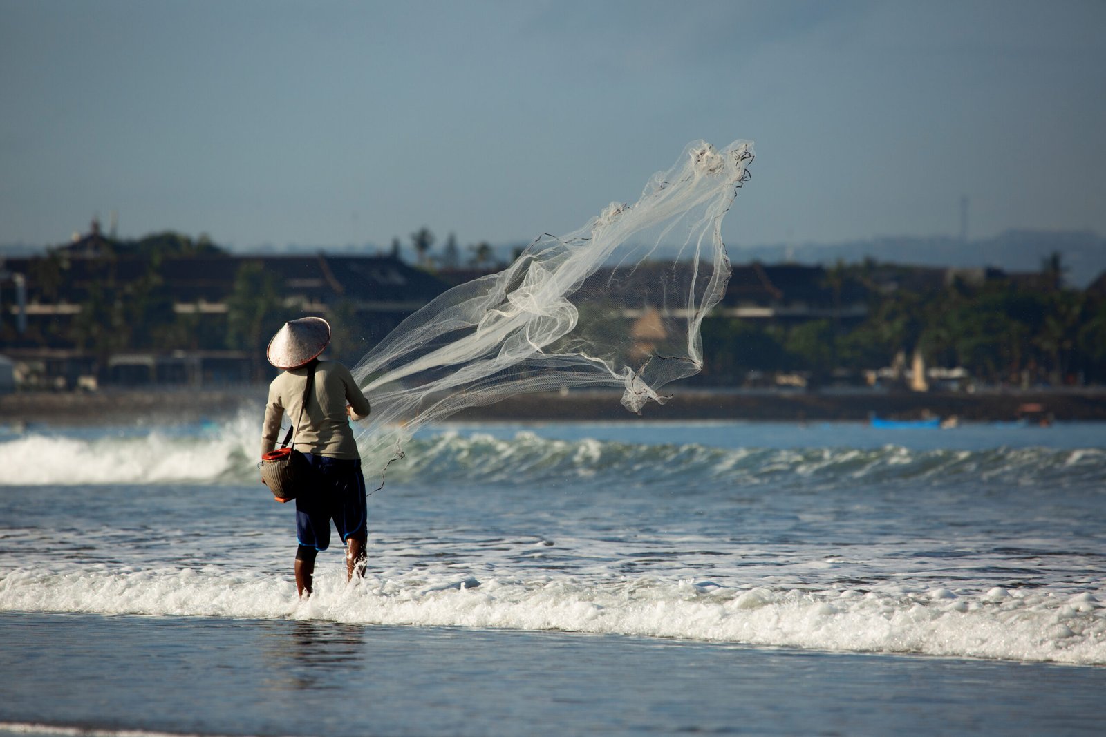 man is fishing with net scaled