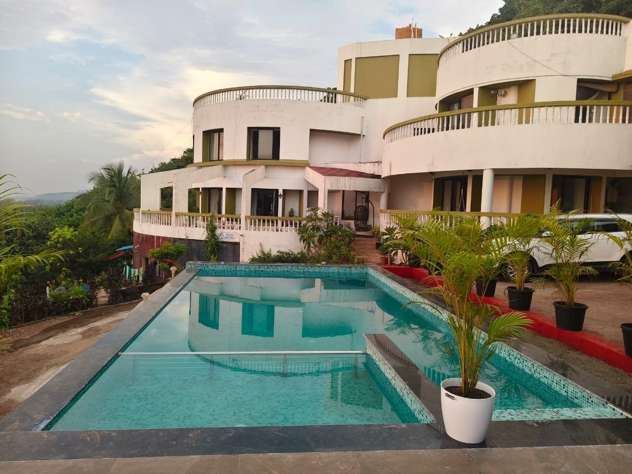 Poolside relaxation area at private pool villa in Dapoli